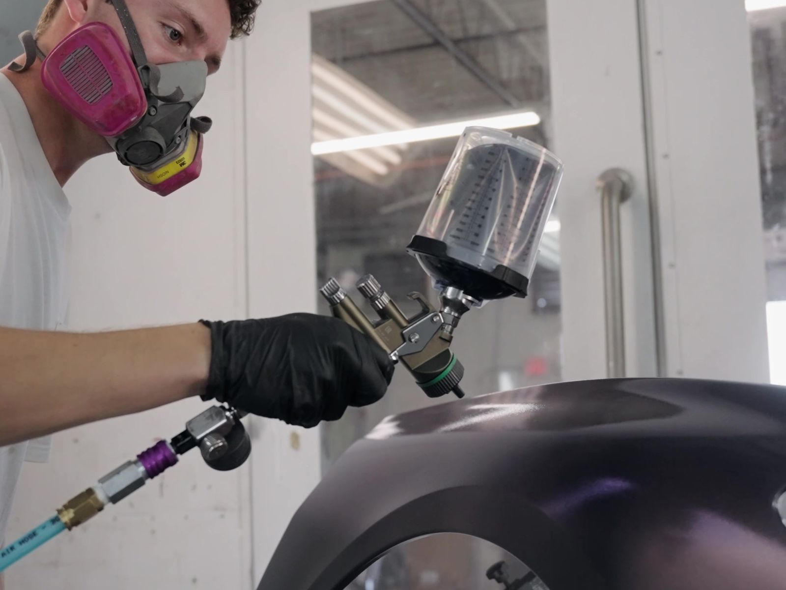 Painter spraying a bumper in the Proline paint booth